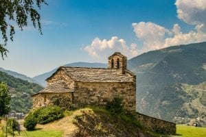 a tiny stone church on top of a mountain in Andorra