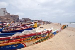 traditional Senegalese boats lined up on the beach 