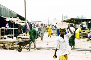 Woman carrying her market purchases on her head in Sierra Leone