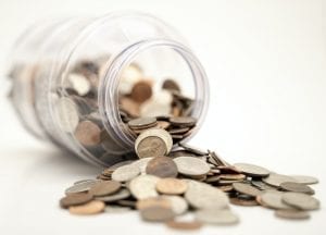 a coin jar, spilling coins 