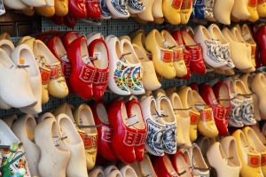 rows of brightly colored clogs for sale