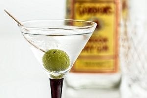 a gin martini cocktail with an olive 