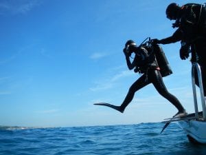 scuba diver starting a dive from a boat