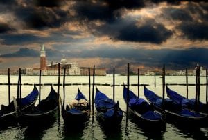 Gondolas moored up under a stormy looking sky