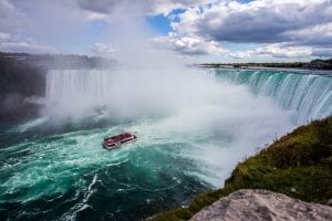A small tourist boat approaching The Niagara Falls, Canada