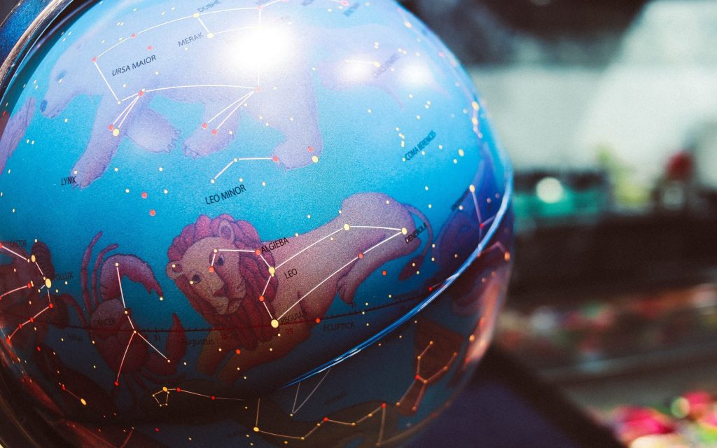 image of a globe with zodiac sign constellations