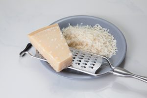 parmesan cheese with a grater