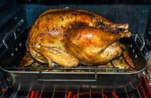 a bronze turkey roasting in the oven
