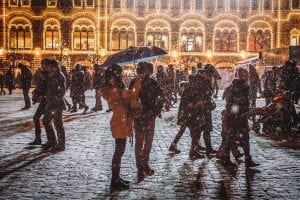 people coming together in a snowy European market place