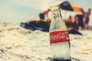 empty Coca Cola bottle on the beach