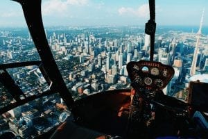 A pilot's eye view of a city from the cockpit of a helicopter