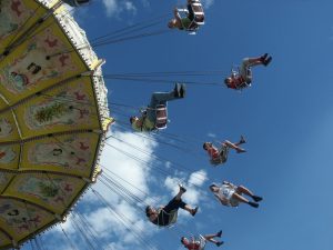 people having fun on a carousel fairground rise