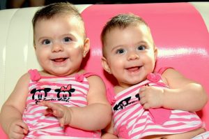 twin babies wearing pink 