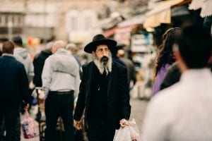 Orthodox religious Jewish man walking in the streets of Jerusalem, near the Mahne Yehuda Shuk, Jerusalem Market.