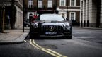 a black Mercedes Benz GT parked of double yellow lines in London