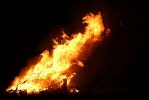 a large bonfire roaring at night