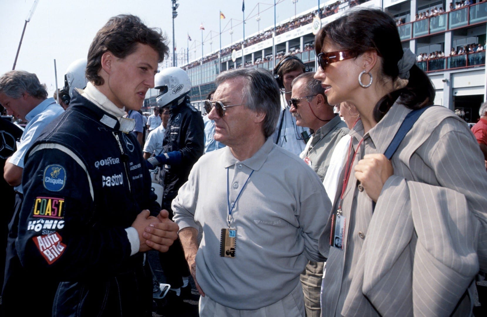 Michael schumacher chatting in the pit lane before racing