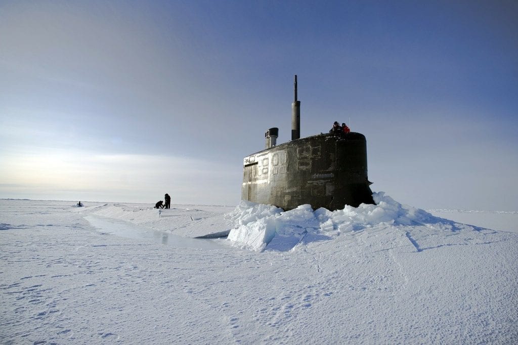 Submarine breaking through sea ice in the Arctic