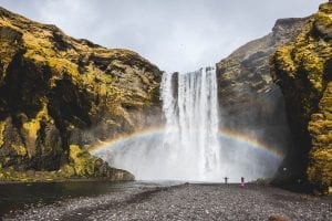 a waterfall casting a rainbow
