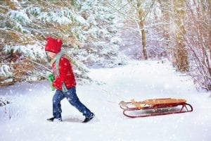 child pulling a sledge in the snow