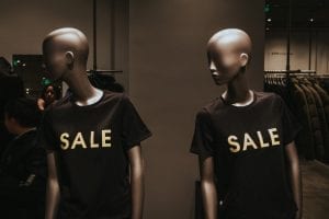 Mannequins wearing black January sale t-shirts