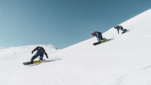 three snowboarders on a mountain