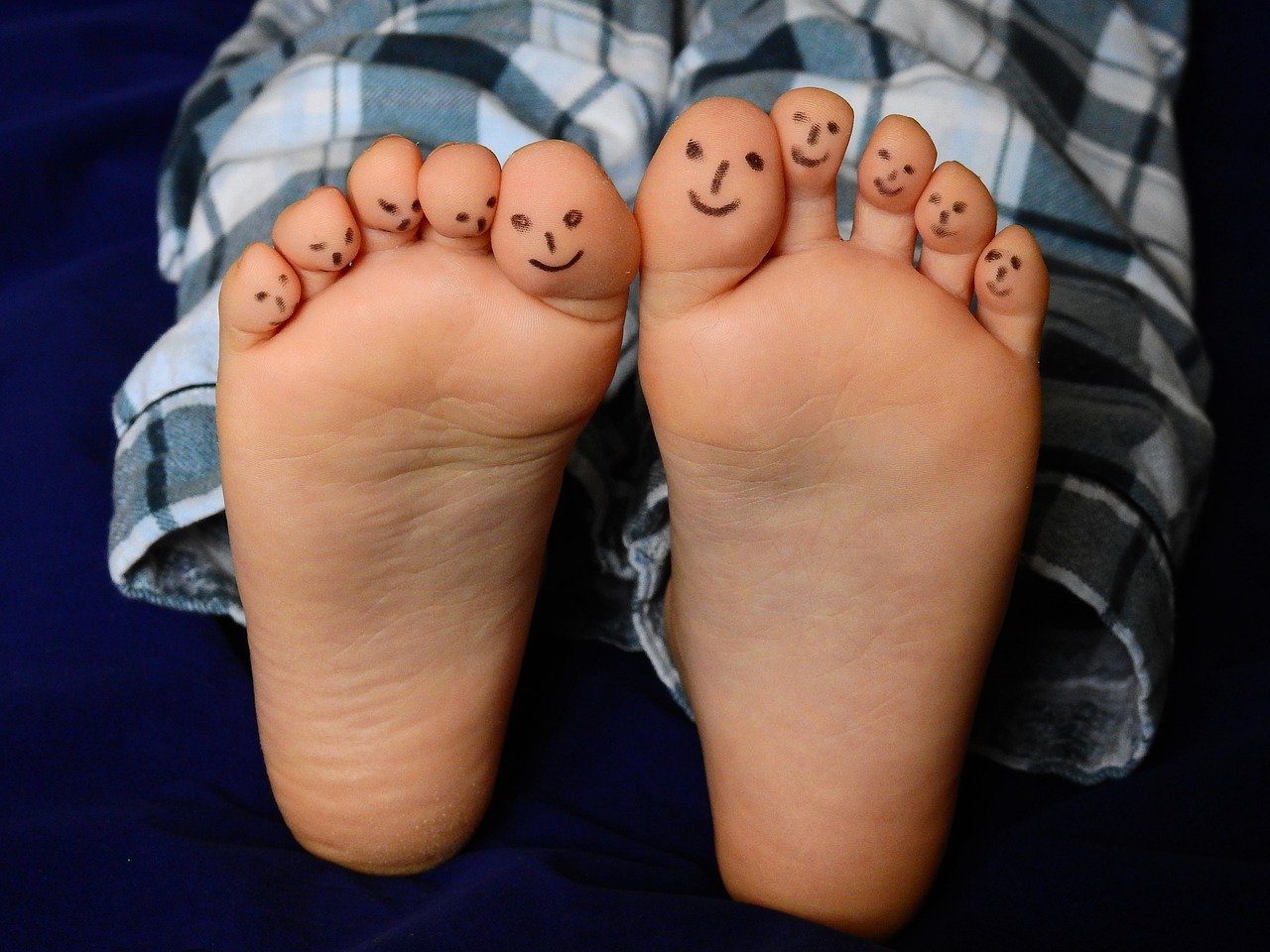 Feet with smily faces on the toes