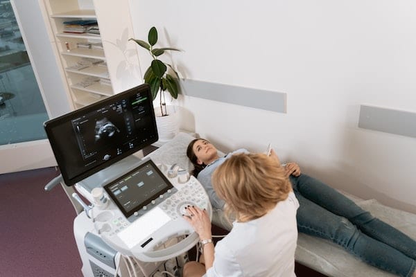 Woman getting ultrasound on pelvis