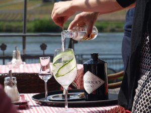 a classic gin and tonic, with cucumber in the glass