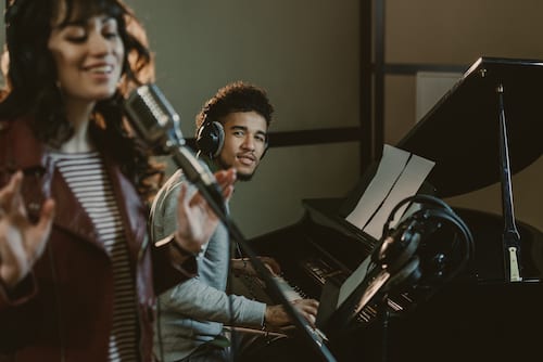 Piano player performing with singer