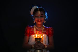 girl holding a Diwali light