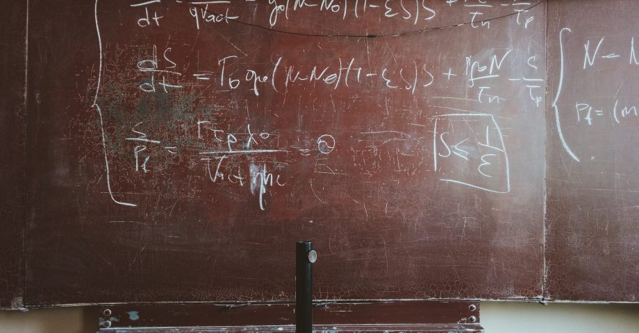 a classroom blackboard showing an mathematical equation