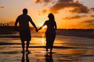 older couple walking on beach